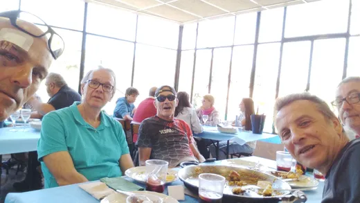 Selfie de cinco zorricos en la mesa del restaurante con la paella ya rematada